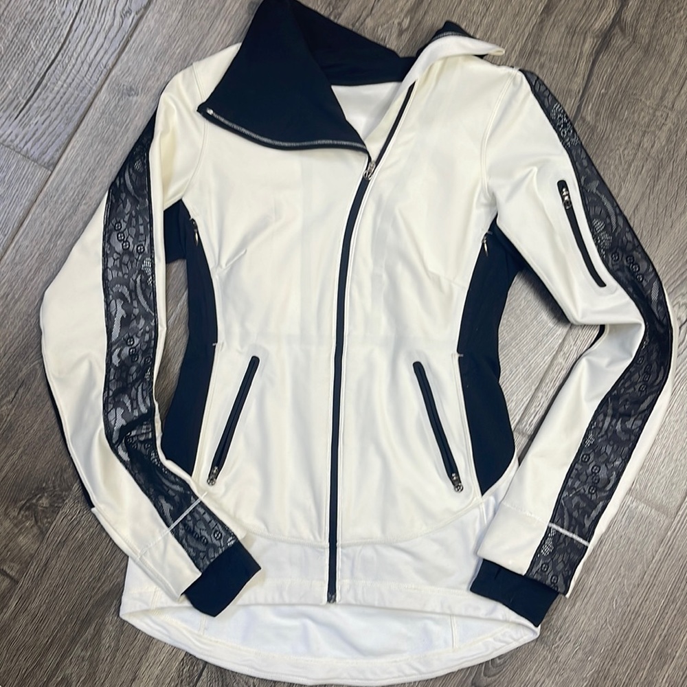 LuLu Lemon Ivory & Cream Jacket. Zippered pockets and lace details on sleeves.